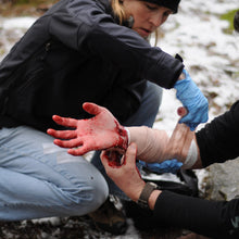 Load image into Gallery viewer, Going beyond bleeding control and learning proper wound management is an important skill taught in a Wilderness First Responder (WFR) course.
