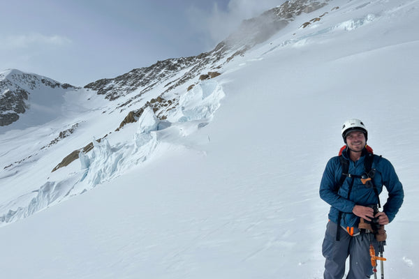 Willy Forsyth in winter clothing with climbing gear on a snowy mountain