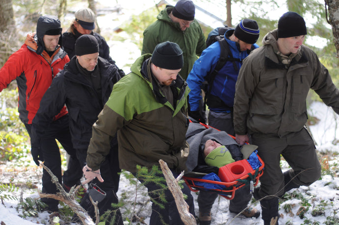 Wilderness First Responder Recertification students practice packaging and transporting patients in litters. 